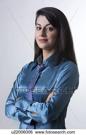 Portrait of confident Indian businesswoman standing arms crossed against gray background View Large Photo Image Stock Photograph - Portrait of confident Indian businesswoman standing arms crossed against gray background. Fotosearch