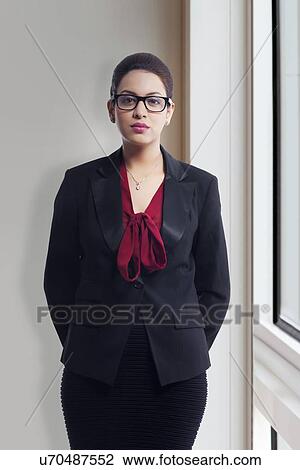 Portrait of confident young businesswoman in office View Large Photo Image Stock Image - Portrait of confident young businesswoman in office. Fotosearch