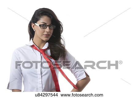 Portrait of confident young stylish businesswoman wearing glasses over white background View Large Photo Image Picture - Portrait of confident young stylish businesswoman wearing glasses over white background. Fotosearch