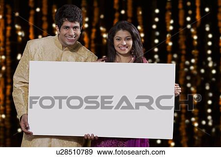 Portrait of couple holding a white board View Large Photo Image Stock Photo - Portrait of couple holding a white board. Fotosearch