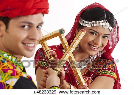 Stock Photo - Portrait of couple with sticks dancing . Fotosearch