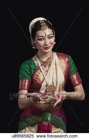 Portrait of dancer gesturing while performing Bharatanatyam against black background View Large Photo Image Stock Photography - Portrait of dancer gesturing while performing Bharatanatyam against black background. Fotosearch