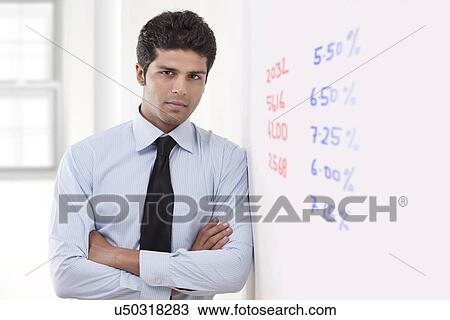 Portrait of executive standing next to white board View Large Photo Image Stock Image - Portrait of executive standing next to white board . Fotosearch