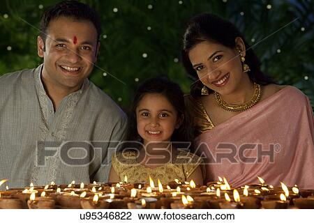 Stock Image - Portrait of family with diyas . Fotosearch