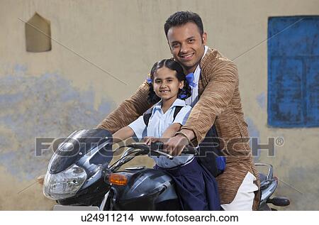 Portrait of father and daughter on motorbike View Large Photo Image Picture - Portrait of father and daughter on motorbike . Fotosearch