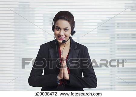 Portrait of female customer service representative greeting in office View Large Photo Image Stock Image - Portrait of female customer service representative greeting in office. Fotosearch