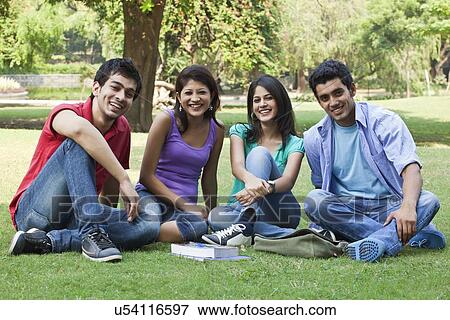 Portrait of friends sitting in lawn View Large Photo Image Stock Photo - Portrait of friends sitting in lawn . Fotosearch