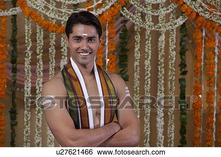 Stock Photograph - Portrait of groom with arms crossed . Fotosearch
