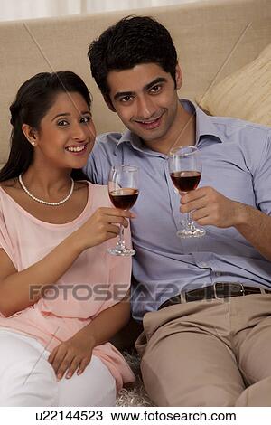 Portrait of happy couple holding wine glass together View Large Photo Image Stock Image - Portrait of happy couple holding wine glass together . Fotosearch