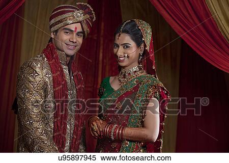 Stock Photography - Portrait of happy couple on their wedding day . Fotosearch