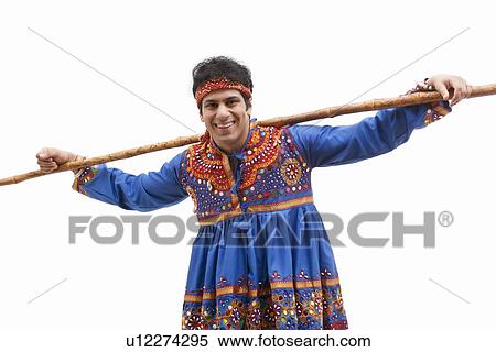 Portrait of happy young man in traditional wear with stick over white background View Large Photo Image Stock Photography - Portrait of happy young man in traditional wear with stick over white background. Fotosearch