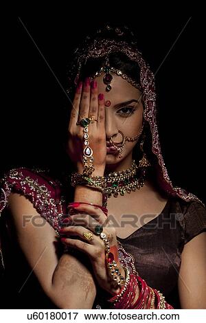 Stock Photo - Portrait of Indian bride hiding half her face . Fotosearch