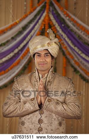 Stock Image - Portrait of Indian groom greeting . Fotosearch