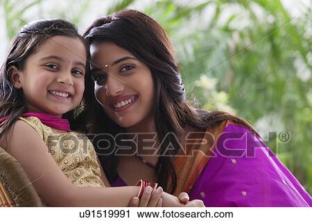 Stock Image - Portrait of mother and daughter . Fotosearch