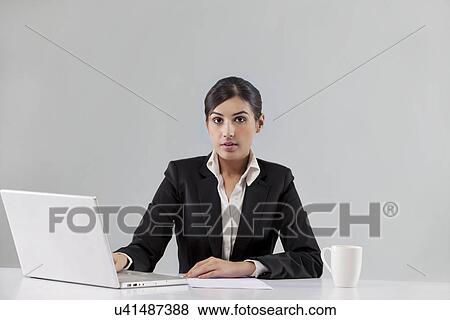 Portrait of news anchor with laptop and coffee against colored background View Large Photo Image Stock Photo - Portrait of news anchor with laptop and coffee against colored background . Fotosearch