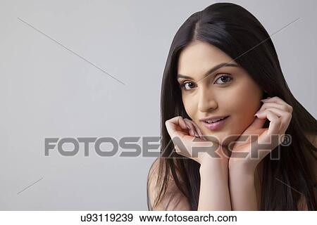 Portrait of pretty young Indian woman with long hair isolated over colored background View Large Photo Image Stock Photo - Portrait of pretty young Indian woman with long hair isolated over colored background . Fotosearch