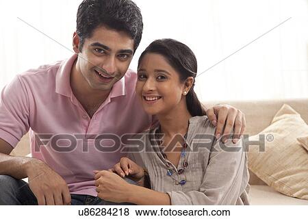 Portrait of relaxed young couple smiling at home  View Large Photo Image Stock Photo - Portrait of relaxed young couple smiling at home . Fotosearch