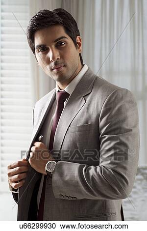 Stock Image - Portrait of smart business man keeping his pen. . Fotosearch