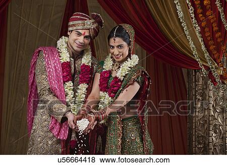 Portrait of smiling bride and bridegroom during traditional ceremony View Large Photo Image Stock Photo - Portrait of smiling bride and bridegroom during traditional ceremony . Fotosearch