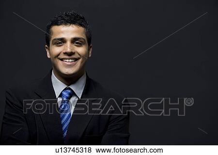 Portrait of smiling business man over black background View Large Photo Image Stock Photo - Portrait of smiling business man over black background . Fotosearch