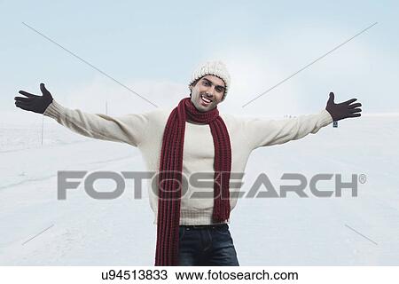 Stock Image - Portrait of smiling man with arms outstretched . Fotosearch