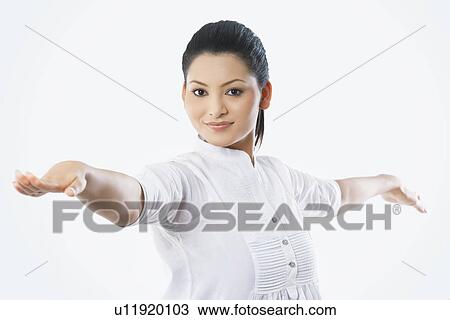 Stock Image - Portrait of smiling woman with arms outstretched . Fotosearch