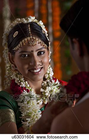 Portrait of smiling woman with her husband during their wedding View Large Photo Image Picture - Portrait of smiling woman with her husband during their wedding . Fotosearch