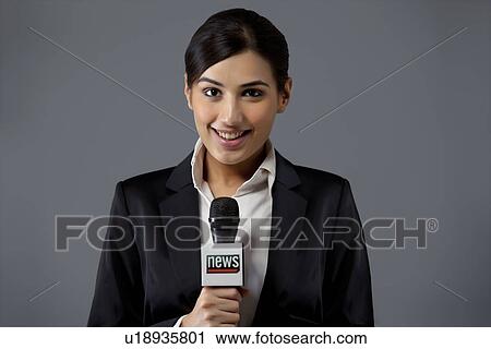 Portrait of smiling young female TV reporter against colored background View Large Photo Image Stock Image - Portrait of smiling young female TV reporter against colored background . Fotosearch