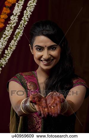 Portrait of smiling young Indian bride showing her henna tattoo View Large Photo Image Stock Photo - Portrait of smiling young Indian bride showing her henna tattoo . Fotosearch
