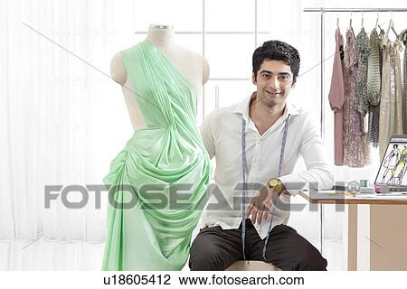 Portrait of smiling young male fashion designer with dressmaker's dummy View Large Photo Image Stock Image - Portrait of smiling young male fashion designer with dressmaker's dummy . Fotosearch