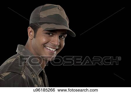 Portrait of smiling young male soldier against black background View Large Photo Image Stock Photograph - Portrait of smiling young male soldier against black background . Fotosearch