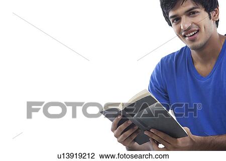Portrait of smiling young man reading book over white background View Large Photo Image Stock Image - Portrait of smiling young man reading book over white background . Fotosearch