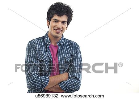 Portrait of smiling young man with arms crossed over background View Large Photo Image Stock Image - Portrait of smiling young man with arms crossed over background . Fotosearch