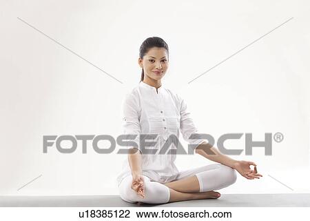 Portrait of smiling young woman meditating View Large Photo Image Stock Image - Portrait of smiling young woman meditating . Fotosearch