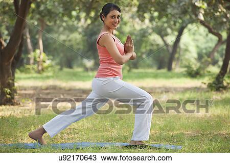 Portrait of smiling young woman practicing yoga View Large Photo Image Stock Image - Portrait of smiling young woman practicing yoga . Fotosearch