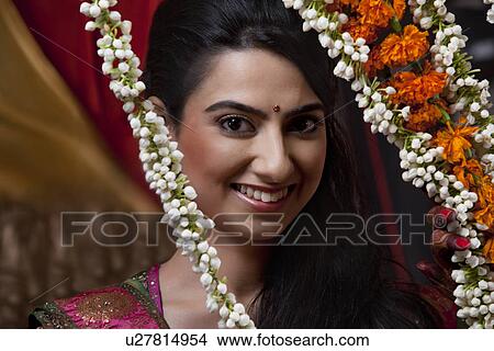 Portrait of smiling young woman with wreath View Large Photo Image Picture - Portrait of smiling young woman with wreath . Fotosearch