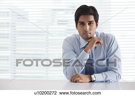 Portrait of successful businessman sitting in office View Large Photo Image Stock Image - Portrait of successful businessman sitting in office . Fotosearch