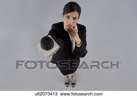Portrait of thoughtful reporter holding out microphone View Large Photo Image Stock Image - Portrait of thoughtful reporter holding out microphone . Fotosearch