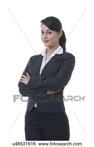 Stock Photograph - Portrait of well-dressed young businesswoman with arms crossed standing over white background. Fotosearch