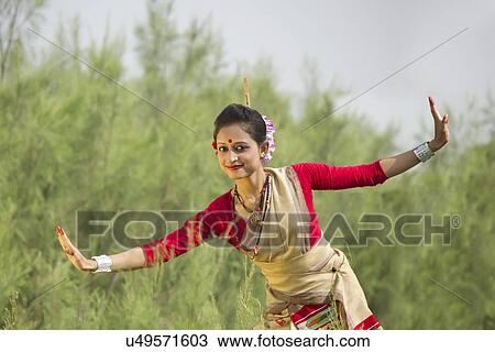 Stock Image - Portrait of woman doing Bihu dance . Fotosearch
