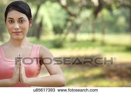 Portrait of woman holding hands in prayer position View Large Photo Image Stock Image - Portrait of woman holding hands in prayer position . Fotosearch