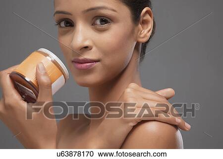 Portrait of woman holding scrub bottle View Large Photo Image Stock Image - Portrait of woman holding scrub bottle . Fotosearch