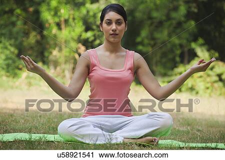Portrait of woman in lawn sitting in lotus position View Large Photo Image Stock Image - Portrait of woman in lawn sitting in lotus position . Fotosearch