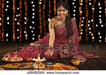 Picture - Portrait of woman making a rangoli. Fotosearch
