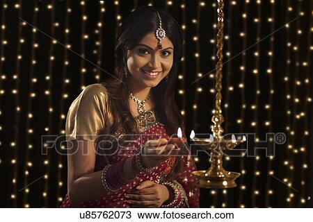 Portrait of woman with a diya View Large Photo Image Stock Image - Portrait of woman with a diya . Fotosearch