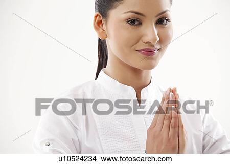 Portrait of woman with hands clasped View Large Photo Image Picture - Portrait of woman with hands clasped . Fotosearch