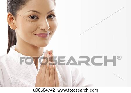 Stock Image - Portrait of woman with hands clasped doing yoga . Fotosearch