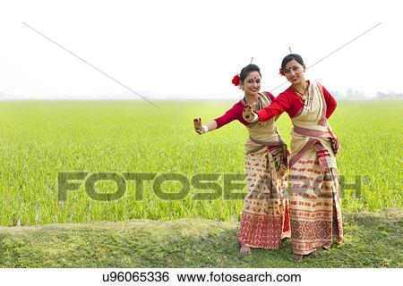 Portrait of women doing Bihu dance View Large Photo Image Stock Photograph - Portrait of women doing Bihu dance . Fotosearch