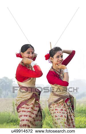Stock Image - Portrait of women performing Bihu dance . Fotosearch
