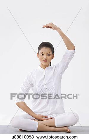 Portrait of young beautiful woman practicing yoga over white background View Large Photo Image Stock Photo - Portrait of young beautiful woman practicing yoga over white background . Fotosearch